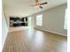 An open floor plan shows a living room with lots of light and a view into the kitchen at 5107 Longmeadow Park St, Orlando, FL 32811