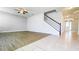 Open-concept living room with hardwood floors connects to tiled foyer and staircase at 5107 Longmeadow Park St, Orlando, FL 32811