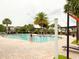 Community pool with a zero entry, brick pavers, palm trees and shaded pergola seating at 5107 Longmeadow Park St, Orlando, FL 32811
