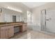 Bright bathroom features a double vanity, soaking tub, and glass-enclosed shower at 5200 Sunset Canyon Dr, Kissimmee, FL 34758