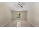 Bedroom with tile flooring, neutral walls, ceiling fan, and a view of the pool at 5200 Sunset Canyon Dr, Kissimmee, FL 34758