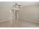 Bedroom with tile flooring, a ceiling fan, and an adjacent hallway with closet space at 5200 Sunset Canyon Dr, Kissimmee, FL 34758