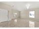 A bright living room with tile floors, a chandelier, and large windows at 5200 Sunset Canyon Dr, Kissimmee, FL 34758
