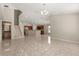 Spacious living room featuring tile flooring, stairs, and an open-concept kitchen at 5200 Sunset Canyon Dr, Kissimmee, FL 34758