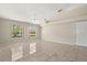 Bright living room with tile flooring, large windows, and a modern light fixture at 5200 Sunset Canyon Dr, Kissimmee, FL 34758