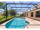 Beautiful screened-in pool with clear water and lush landscaping at 5200 Sunset Canyon Dr, Kissimmee, FL 34758