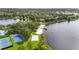Aerial view showcasing community beach, sports courts, and lakeside amenities at 5235 Keenes Pheasant Dr, Windermere, FL 34786