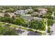 Aerial view showcasing the well-maintained townhome with a tree-lined street in a serene neighborhood at 5235 Keenes Pheasant Dr, Windermere, FL 34786