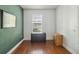 Bedroom showcasing the clean lines, neutral tones and dark wood floor that could be used as an office at 5235 Keenes Pheasant Dr, Windermere, FL 34786