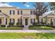 Charming two-story townhome featuring a welcoming entrance with black shutters and a well-manicured lawn at 5235 Keenes Pheasant Dr, Windermere, FL 34786