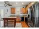 The kitchen features wooden cabinets, a black refrigerator and oven, with a wooden island at 5235 Keenes Pheasant Dr, Windermere, FL 34786
