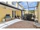 Enclosed patio with brick and concrete, partially filled with various items at 5235 Keenes Pheasant Dr, Windermere, FL 34786