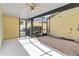 Enclosed patio with fan has a paved section and planting bed, bright sunlit space at 5235 Keenes Pheasant Dr, Windermere, FL 34786