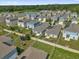 Neighborhood aerial view featuring fenced yards, community landscaping, and a nearby lake creating a serene environment at 555 Jett Ln, Davenport, FL 33837