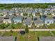 Aerial view of a residential community showing fenced backyards, lush green spaces, and houses with solar panels at 555 Jett Ln, Davenport, FL 33837