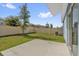 A well-maintained backyard with green grass, a concrete patio, and a privacy fence offers an ideal outdoor living space at 555 Jett Ln, Davenport, FL 33837