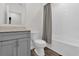 Bright bathroom featuring a single vanity and a shower/tub combo with white tile surround at 555 Jett Ln, Davenport, FL 33837