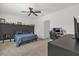 Bedroom features a ceiling fan, blue bedspread and a desk for working or studying at 555 Jett Ln, Davenport, FL 33837
