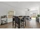 Dining area featuring a sleek table set, tile floors and an open layout to the living area at 555 Jett Ln, Davenport, FL 33837