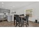 Open kitchen with gray cabinetry, stainless steel appliances and breakfast bar with seating area at 555 Jett Ln, Davenport, FL 33837
