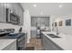 Stylish kitchen with stainless steel appliances, gray cabinetry and a convenient breakfast bar at 555 Jett Ln, Davenport, FL 33837