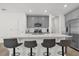 Modern kitchen featuring stainless steel appliances, gray cabinets and a breakfast bar with seating at 555 Jett Ln, Davenport, FL 33837