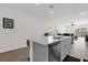 Kitchen featuring an island with sink and dishwasher open to the main living area at 555 Jett Ln, Davenport, FL 33837