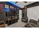 Living room with custom paint, movie posters, and a dark media center at 555 Jett Ln, Davenport, FL 33837