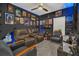 Cozy living room with custom dark paint, movie posters and a brown leather sofa at 555 Jett Ln, Davenport, FL 33837