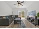 Bright living room featuring a ceiling fan, tile floors and access to outdoor patio at 555 Jett Ln, Davenport, FL 33837