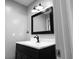 Bathroom features a black framed mirror and dark vanity at 5607 Spring Run Ave, Orlando, FL 32819