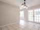 Dining room featuring tile flooring, elegant lighting fixture, and French doors leading to the outside at 5607 Spring Run Ave, Orlando, FL 32819