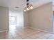 Spacious dining room with tile floors and modern light fixture at 5607 Spring Run Ave, Orlando, FL 32819