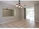 Inviting dining room with tile flooring, modern lighting, and a large mirror, great for entertaining at 5607 Spring Run Ave, Orlando, FL 32819