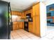 Functional kitchen with wooden cabinetry, granite countertops, and modern black appliances at 5607 Spring Run Ave, Orlando, FL 32819