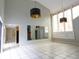 Bright living room with high ceilings, tile flooring, and unique pendant lighting, plus large windows at 5607 Spring Run Ave, Orlando, FL 32819