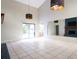 Open living room with tile flooring, modern lighting fixtures, and a sliding door to the pool at 5607 Spring Run Ave, Orlando, FL 32819