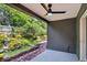 Covered patio space with brick trim overlooking a peaceful, lush backyard and water feature at 632 Bridge Creek Blvd, Ocoee, FL 34761