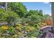 Secluded backyard boasts a serene pond, waterfall feature, and a stone-lined brick path at 632 Bridge Creek Blvd, Ocoee, FL 34761