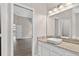 Bathroom with marble countertops, vanity, and door to the bedroom at 632 Bridge Creek Blvd, Ocoee, FL 34761