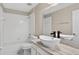 Clean bathroom featuring a white tile shower-tub, marble countertop, and modern fixtures at 632 Bridge Creek Blvd, Ocoee, FL 34761