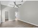Spacious bedroom with wood-look flooring, a ceiling fan, and ensuite bathroom access at 632 Bridge Creek Blvd, Ocoee, FL 34761