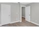 Bedroom featuring closets and doorway, completed with gray walls and wood-look flooring at 632 Bridge Creek Blvd, Ocoee, FL 34761
