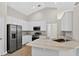 Modern kitchen features white cabinets, stainless steel appliances, and beautiful granite countertops at 632 Bridge Creek Blvd, Ocoee, FL 34761