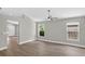 Spacious living room with wood-look floors, neutral paint, and plenty of natural light from two windows at 632 Bridge Creek Blvd, Ocoee, FL 34761
