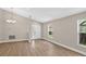 Open living room with wood-look flooring, recessed lights, and a chandelier at 632 Bridge Creek Blvd, Ocoee, FL 34761