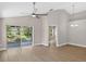 Bright living room featuring wood-look floors, vaulted ceilings, and sliding glass doors to the patio at 632 Bridge Creek Blvd, Ocoee, FL 34761