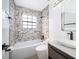 Full bathroom with designer tile in shower/bath, stylish vanity, and modern fixtures create a luxurious retreat at 6512 Grosvenor Ln, Orlando, FL 32835