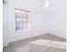 Bright bedroom with wood floors, ceiling fan, and a large window offering plenty of natural light and a view at 6512 Grosvenor Ln, Orlando, FL 32835