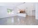 Spacious living room with tile floors, large windows, and open access to the kitchen, flooded with natural light at 6512 Grosvenor Ln, Orlando, FL 32835